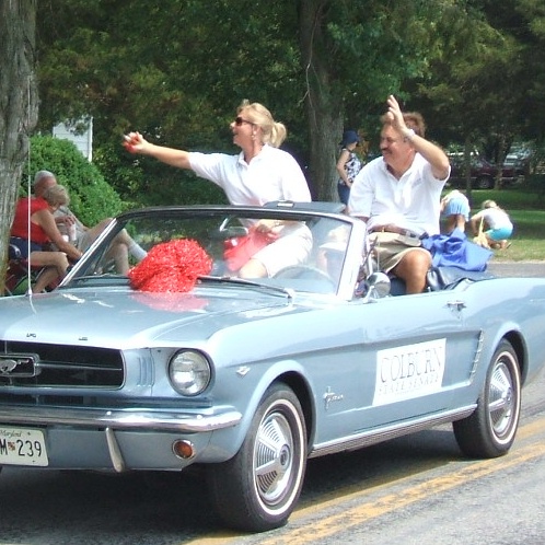 Senator Rich Colburn waves to the crowd at the July 4th parade in Allen.